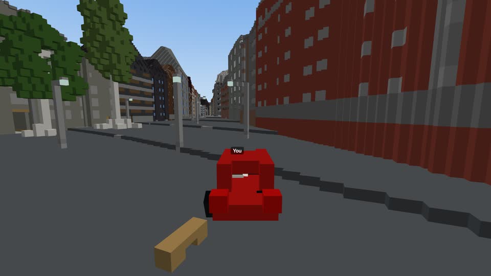 A red car driving down a street, seen from behind